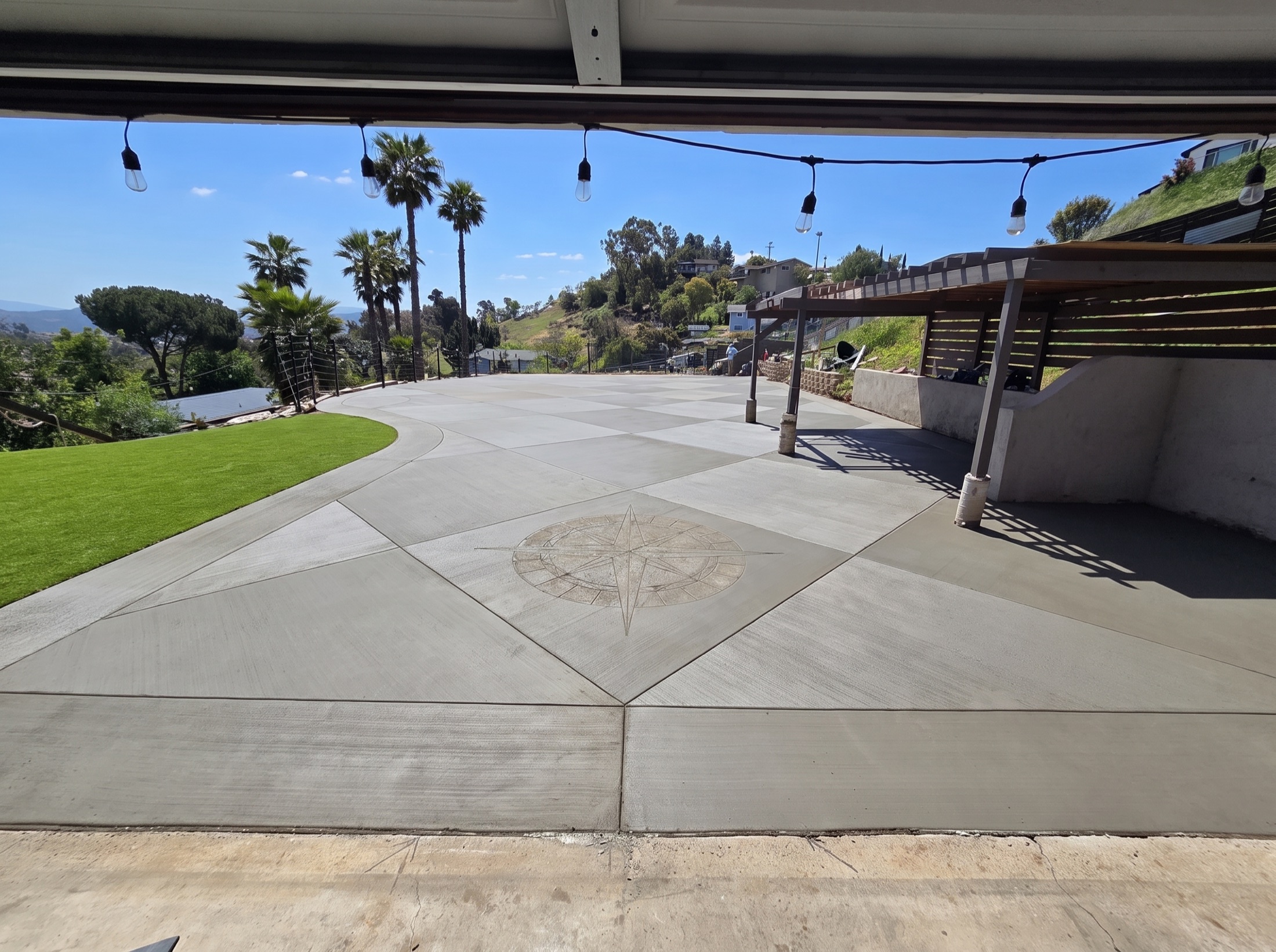Residential concrete driveway with a decorative medallion